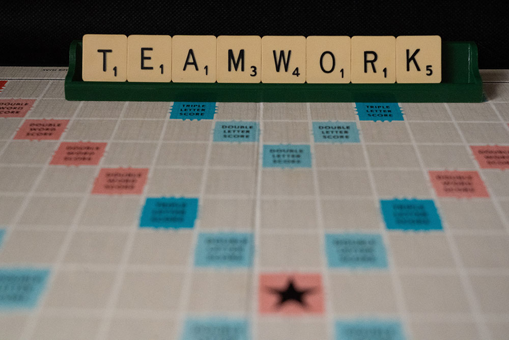 Scrabble pieces spelling "TEAMWORK"